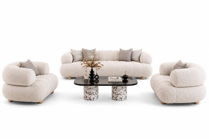 The Ivory Cocoon Lounge Set featuring a 3-seater curved channel-tufted sofa and two matching armchairs around a coffee table
